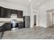 Bright kitchen with stainless steel appliances, dark cabinets, and modern flooring at 3222 Enclave Ln, Greenwood, IN 46143