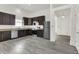 Kitchen with dark cabinets, stainless steel appliances, and modern flooring at 3222 Enclave Ln, Greenwood, IN 46143