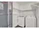 Convenient laundry room with modern washer, dryer, and plenty of shelving at 3222 Enclave Ln, Greenwood, IN 46143