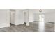 Spacious living room with gray wood floors, neutral walls, and modern lighting at 3222 Enclave Ln, Greenwood, IN 46143