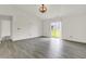 Bright, open living room with sliding glass doors and modern gray flooring at 3222 Enclave Ln, Greenwood, IN 46143