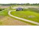 Picturesque aerial shot of a home with a long driveway surrounded by lush greenery at 3319 E 700 N, Whiteland, IN 46184