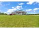 Expansive backyard with a deck, hot tub, and green lawn, creating a serene outdoor living space at 3319 E 700 N, Whiteland, IN 46184