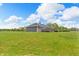Large backyard with lush green grass, wooden deck, and shed, offering ample space for outdoor activities and storage at 3319 E 700 N, Whiteland, IN 46184