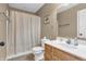 Cozy bathroom with shower-tub combo, wooden vanity, mirror, and neutral color scheme at 3319 E 700 N, Whiteland, IN 46184