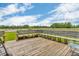 Large wooden deck with seating, perfect for outdoor dining and relaxation overlooking the lush green lawn at 3319 E 700 N, Whiteland, IN 46184