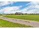 A well-maintained brick house surrounded by a lush green field under a beautiful sky at 3319 E 700 N, Whiteland, IN 46184