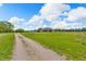 Long driveway leading to a beautiful home with a large yard, offering privacy and ample space for outdoor activities at 3319 E 700 N, Whiteland, IN 46184