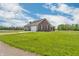Charming home with a brick facade, attached garage, and spacious yard, under a sunny sky at 3319 E 700 N, Whiteland, IN 46184