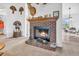 Close-up of a brick fireplace with a wooden mantel and decorative accents at 3319 E 700 N, Whiteland, IN 46184