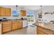 Eat-in kitchen with wood cabinets and stainless appliances, leads to walk-out patio with a view at 3319 E 700 N, Whiteland, IN 46184