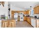 Functional kitchen with light wood cabinets, white appliances, and eat in seating at 3319 E 700 N, Whiteland, IN 46184
