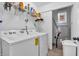 Bright laundry area with washer, dryer, shelving and utility closet with the HVAC system at 3319 E 700 N, Whiteland, IN 46184
