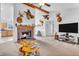 Bright living room featuring a brick fireplace, television, and comfortable seating at 3319 E 700 N, Whiteland, IN 46184
