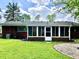 A backyard with green grass, brick construction and an enclosed porch area at 3633 Tiffany Dr, Indianapolis, IN 46226