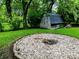The backyard features a fire pit and a weathered wooden shed at 3633 Tiffany Dr, Indianapolis, IN 46226