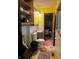 A full bathroom with unique retro features like patterned floors and walls and colorful fixtures at 3633 Tiffany Dr, Indianapolis, IN 46226