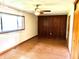 Spacious bedroom featuring wood-look flooring, a ceiling fan, and a large window for natural light at 3633 Tiffany Dr, Indianapolis, IN 46226