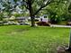 A shot of the front yard with green grass and a few cars parked nearby at 3633 Tiffany Dr, Indianapolis, IN 46226