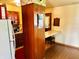 Eat-in kitchen featuring vintage cabinetry, adjacent to wood-floored dining area with natural light at 3633 Tiffany Dr, Indianapolis, IN 46226