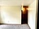 Cozy carpeted room featuring a glimpse of the hallway and a blank wall ready for personalization at 3633 Tiffany Dr, Indianapolis, IN 46226