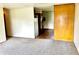 Open living space with carpeted floor, transition to a kitchen space with wood floors visible at 3633 Tiffany Dr, Indianapolis, IN 46226