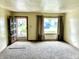 Cozy living room with neutral carpet, large window with natural light, and a view of the neighborhood at 3633 Tiffany Dr, Indianapolis, IN 46226