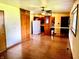 Bright, open living space featuring a ceiling fan and transition to a kitchen with wooden cabinetry at 3633 Tiffany Dr, Indianapolis, IN 46226