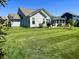 View of the backyard and patio, surrounded by lush green lawn at 3691 Talmine Ln, Bargersville, IN 46106