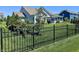 View of the backyard showing the home's black metal fence and lush green lawn at 3691 Talmine Ln, Bargersville, IN 46106