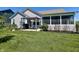 Landscaped backyard with a pergola and outdoor seating, a screened-in porch, and lush green grass at 3691 Talmine Ln, Bargersville, IN 46106