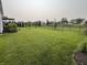 Spacious backyard featuring a large lawn and black metal fence at 3691 Talmine Ln, Bargersville, IN 46106