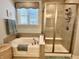 Bright bathroom featuring a bathtub, walk-in shower, and stylish fixtures at 3691 Talmine Ln, Bargersville, IN 46106