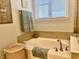 Bathroom with a bathtub, tile walls, and a window with a view at 3691 Talmine Ln, Bargersville, IN 46106