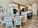 A dining room with a round table, chairs, and a nearby kitchen with counter seating at 3691 Talmine Ln, Bargersville, IN 46106