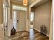 Inviting foyer with wood floors, decorative vase and a view into a bright office space at 3691 Talmine Ln, Bargersville, IN 46106