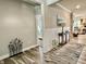 View of the foyer with wood floors, a decorative metal sculpture and a peak into the bedroom at 3691 Talmine Ln, Bargersville, IN 46106