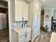 A hallway with a storage cabinet and countertop beside a closed door, creating additional space at 3691 Talmine Ln, Bargersville, IN 46106
