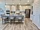 Bright kitchen with white cabinetry, stainless appliances, kitchen island, and hardwood flooring at 3691 Talmine Ln, Bargersville, IN 46106