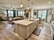 Open-concept kitchen with stainless steel appliances, a large island, and hardwood floors at 3691 Talmine Ln, Bargersville, IN 46106