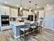 Modern kitchen with white cabinetry, stainless steel appliances, an island, and pendant lighting at 3691 Talmine Ln, Bargersville, IN 46106