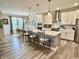 A view of the kitchen with a large island and barstool seating that is connected to the dining area at 3691 Talmine Ln, Bargersville, IN 46106