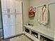 Functional mudroom with storage cabinets, a bench, and a rug creating an organized space at 3691 Talmine Ln, Bargersville, IN 46106