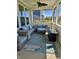 Inviting screened-in porch with comfortable seating, rug, and a fire pit, perfect for relaxing at 3691 Talmine Ln, Bargersville, IN 46106