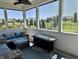 Comfortable screened porch featuring stylish seating, a modern fire table, and neighborhood views at 3691 Talmine Ln, Bargersville, IN 46106