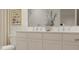 Well-lit bathroom featuring a double vanity with modern faucets, a decorative plant, and a stylish mirror at 3882 Andean Ct, Bargersville, IN 46106