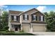 Charming townhome featuring a two-car garage and inviting covered entrance with shingle and siding details at 3882 Andean Ct, Bargersville, IN 46106