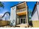 Two story home with wood deck, second-story balcony, sliding glass doors and wood fence at 39 N Walcott St, Indianapolis, IN 46201