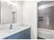 Bright bathroom featuring a stylish vanity with a modern mirror and tiled shower/tub combo at 39 N Walcott St, Indianapolis, IN 46201