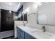 Double sink bathroom with modern vanity, stylish mirrors and a glass door shower with tile at 39 N Walcott St, Indianapolis, IN 46201